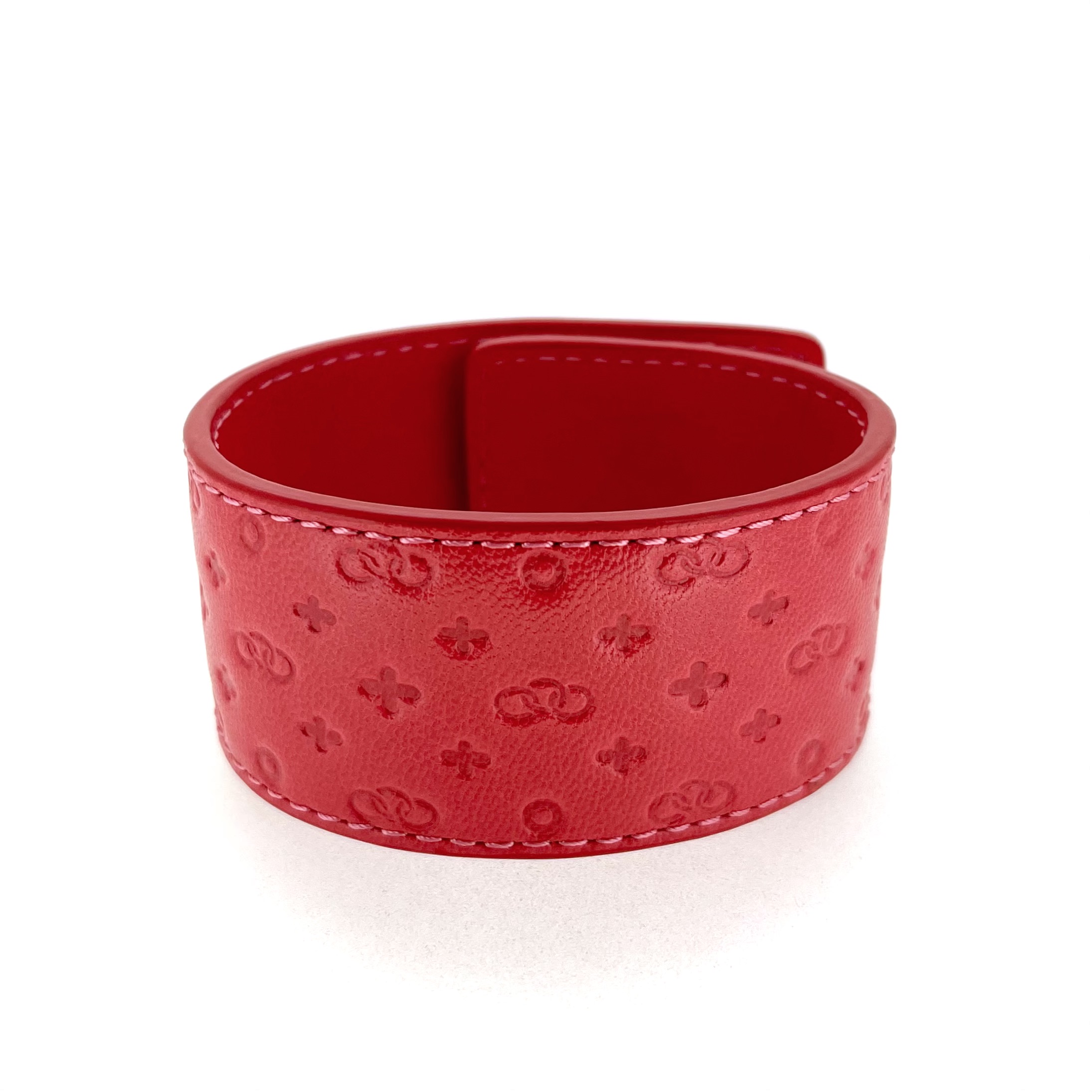 Wide red leather cuff embossed pattern detail