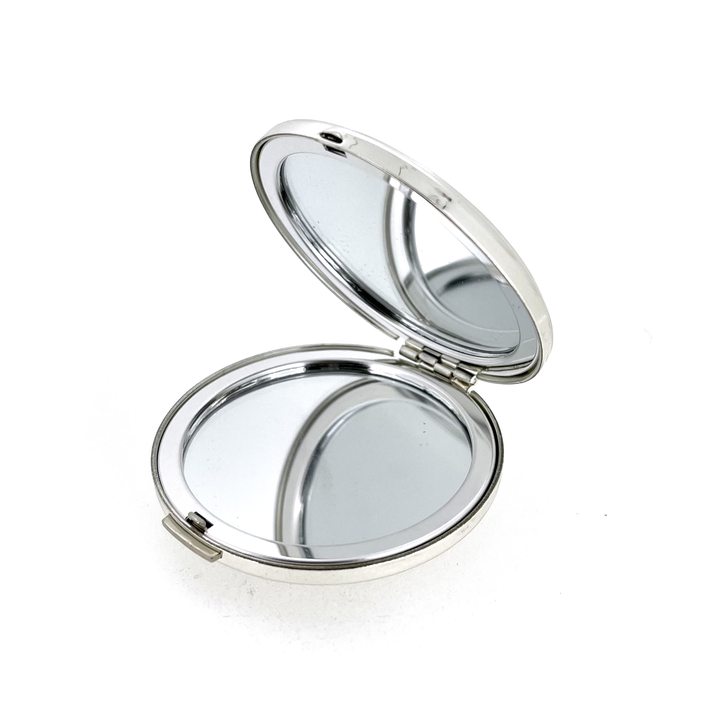 Compact mirror interior showing two reflective surfaces