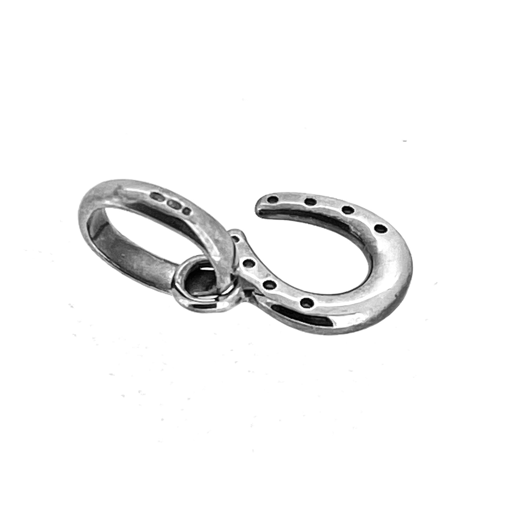 Close-up of sterling silver horseshoe charm showing polished finish