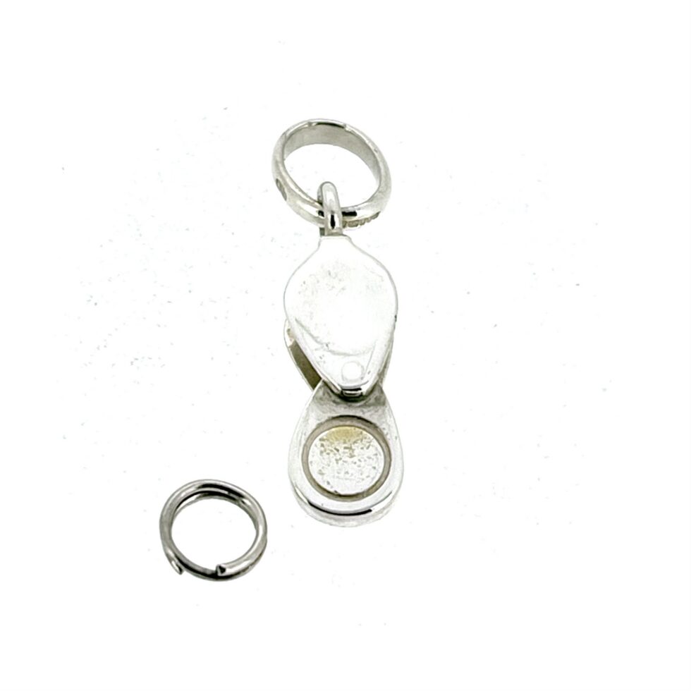 Loupe charm open showing magnifying lens