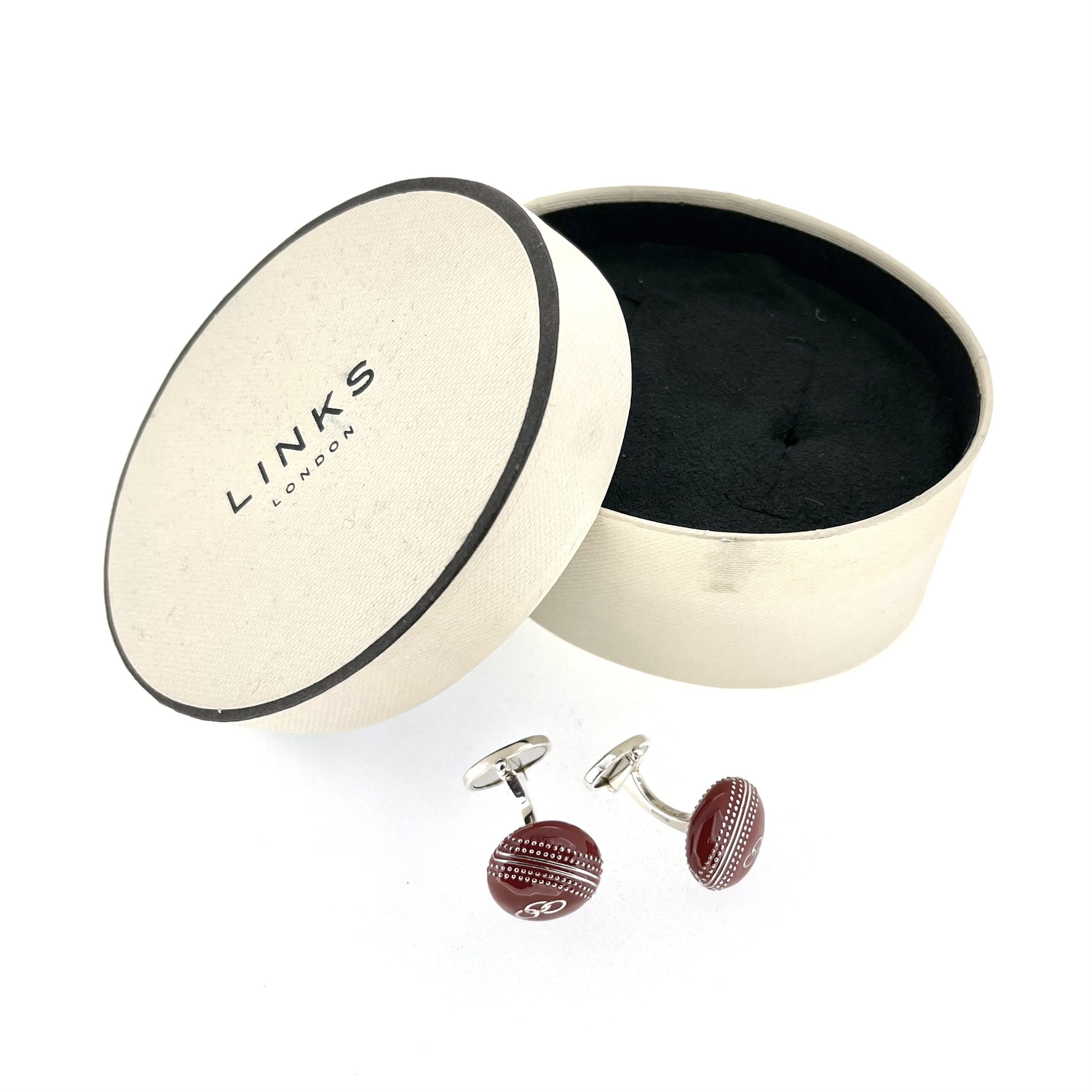 Pair of red enamel cufflinks on white background