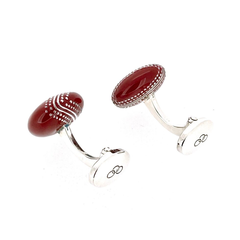 Red enamel cufflinks with three ring logo detail