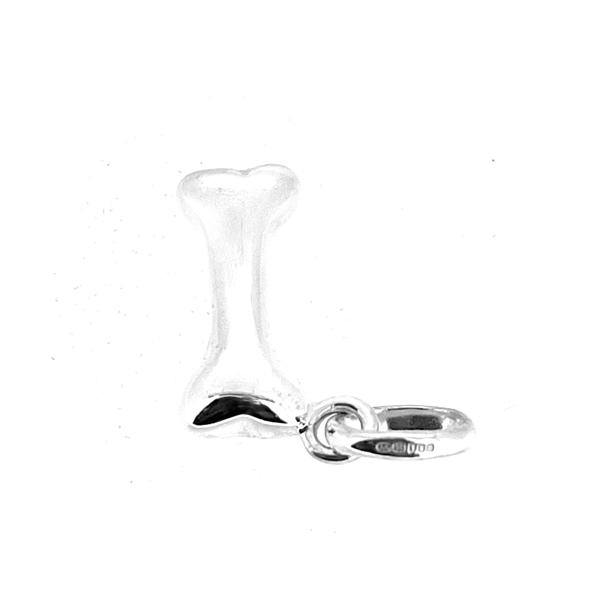Angled view of vintage dog bone charm with standard oval bail