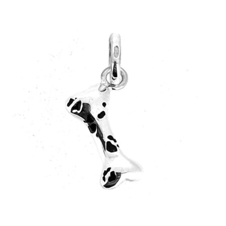 Angled view of vintage dog bone charm with standard oval bail