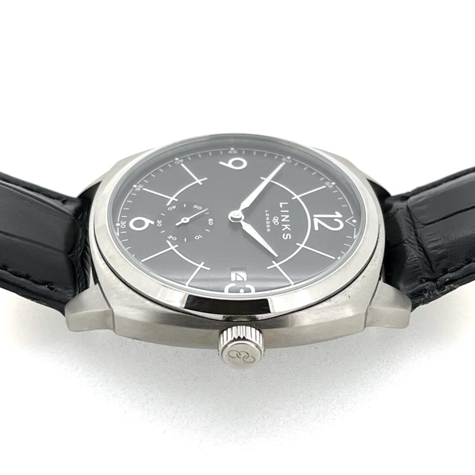 Links of London black dial watch with white Arabic numerals close up