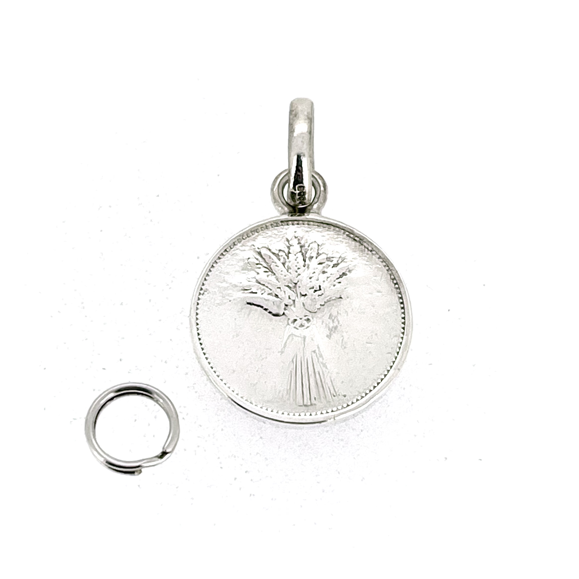 Reverse side of sterling silver coin pendant charm showing wheatsheaf design