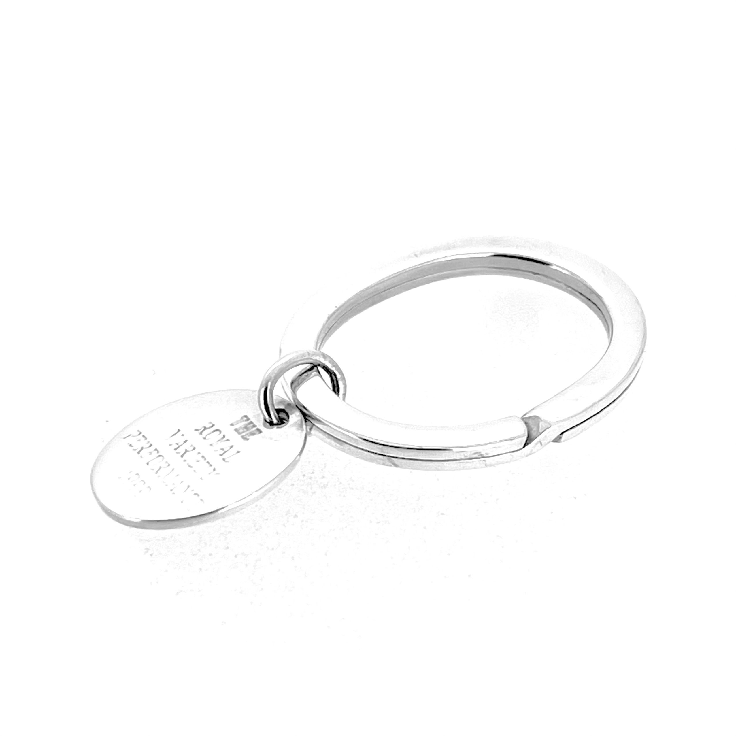 Side view of sterling silver oval keyring with suspended engraved tag