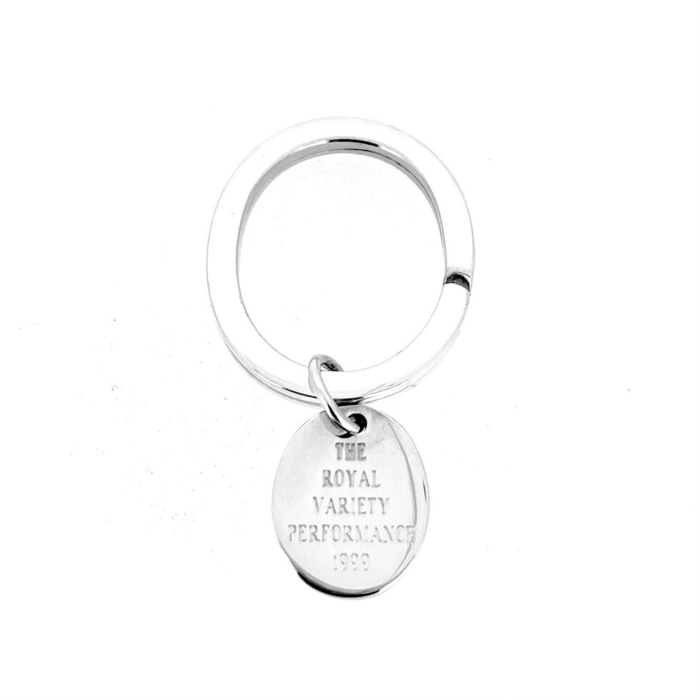 Angled view of vintage Links of London silver keyring with commemorative fob
