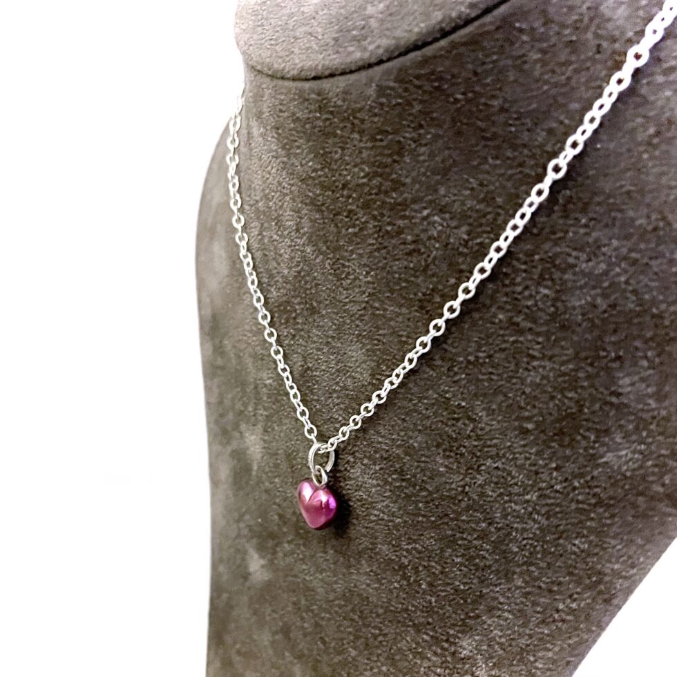 Vintage mini puffed heart necklace showing rounded heart shape and purple finish