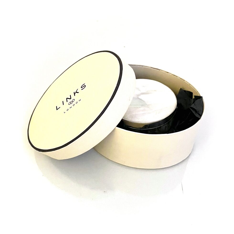 Vintage Links of London silver box displayed with original round presentation box