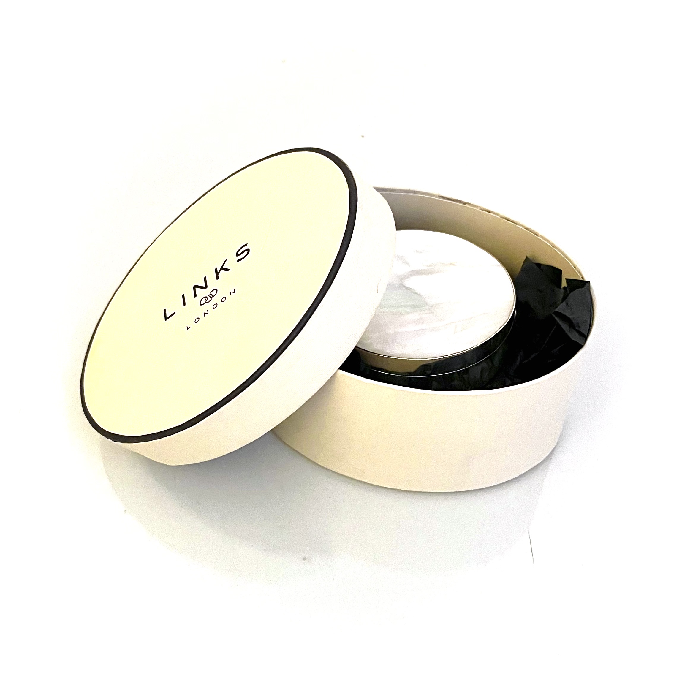 Vintage Links of London silver box displayed with original round presentation box