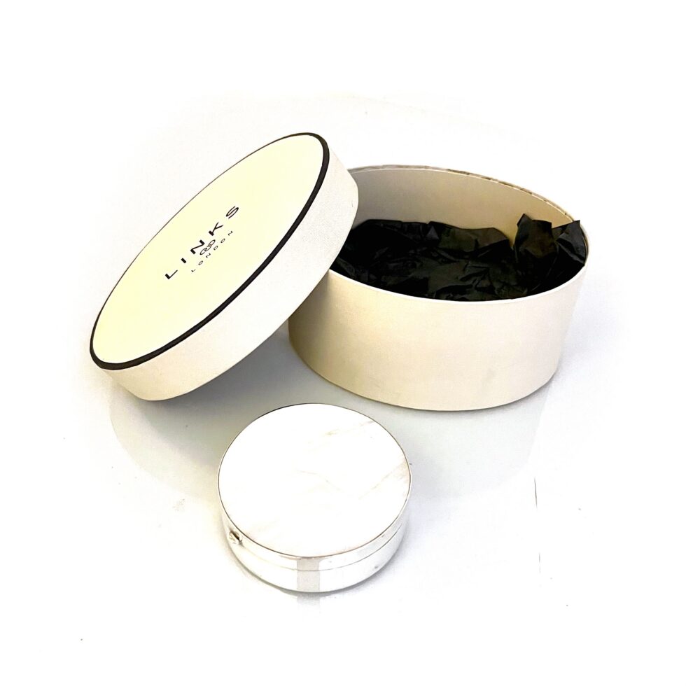 Vintage Links of London silver box displayed with original round presentation box