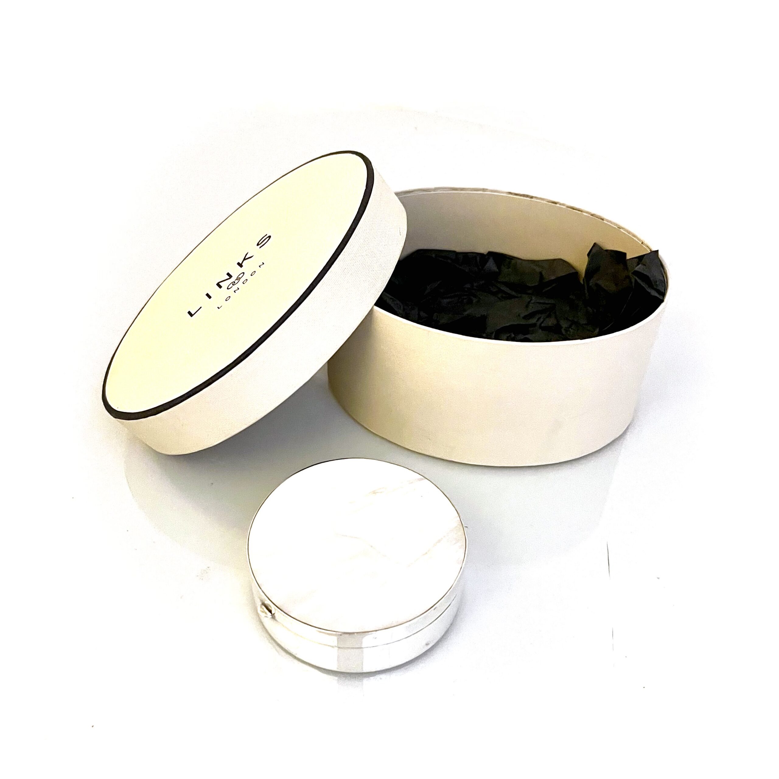 Vintage Links of London silver box displayed with original round presentation box