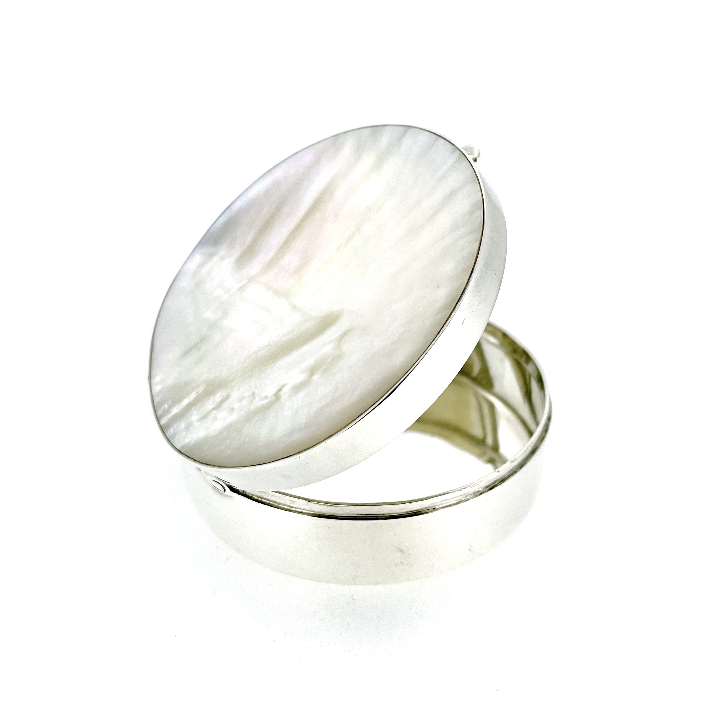 Vintage silver box with round body and shell-like mother-of-pearl lid