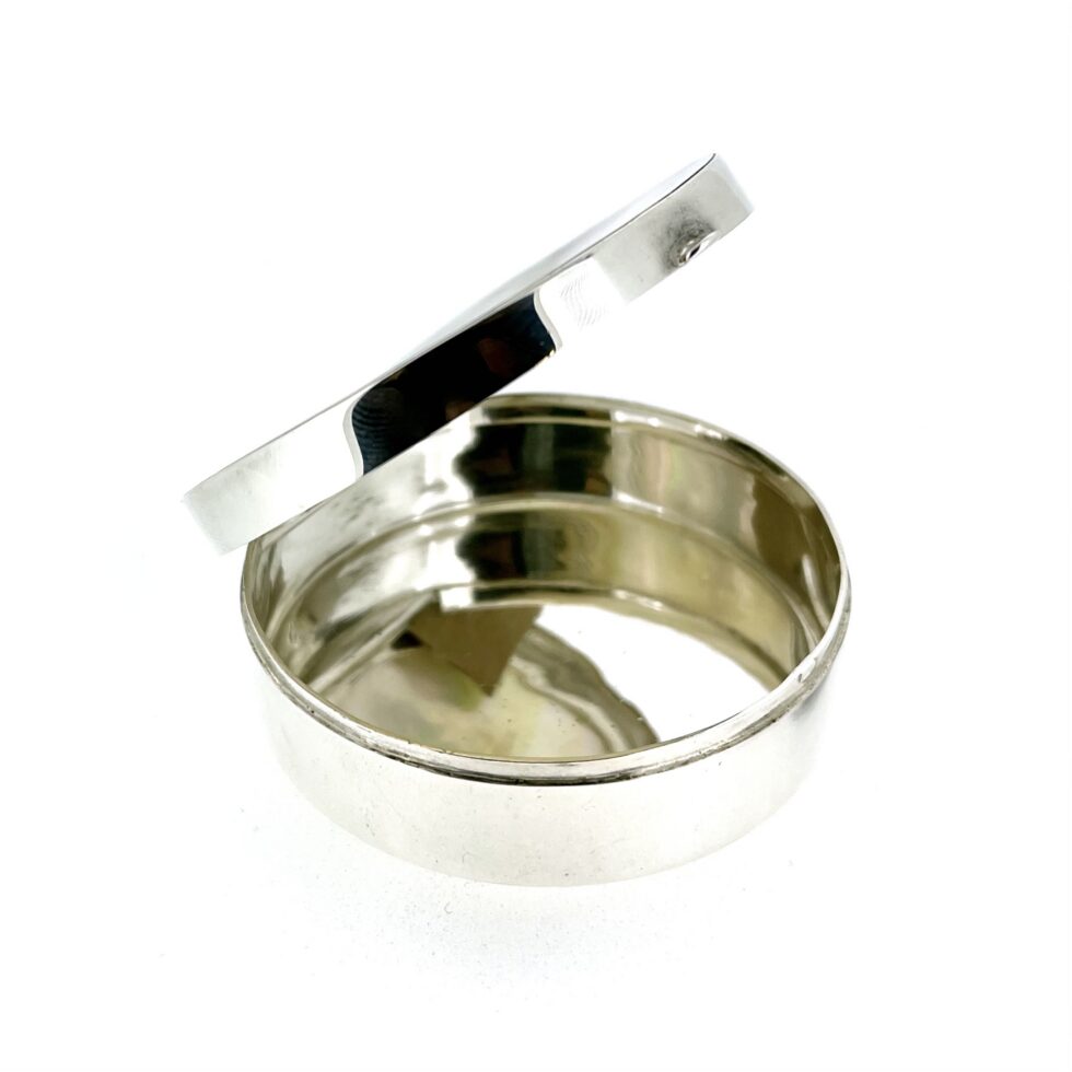 Open view of mother-of-pearl silver trinket box showing hinged lid