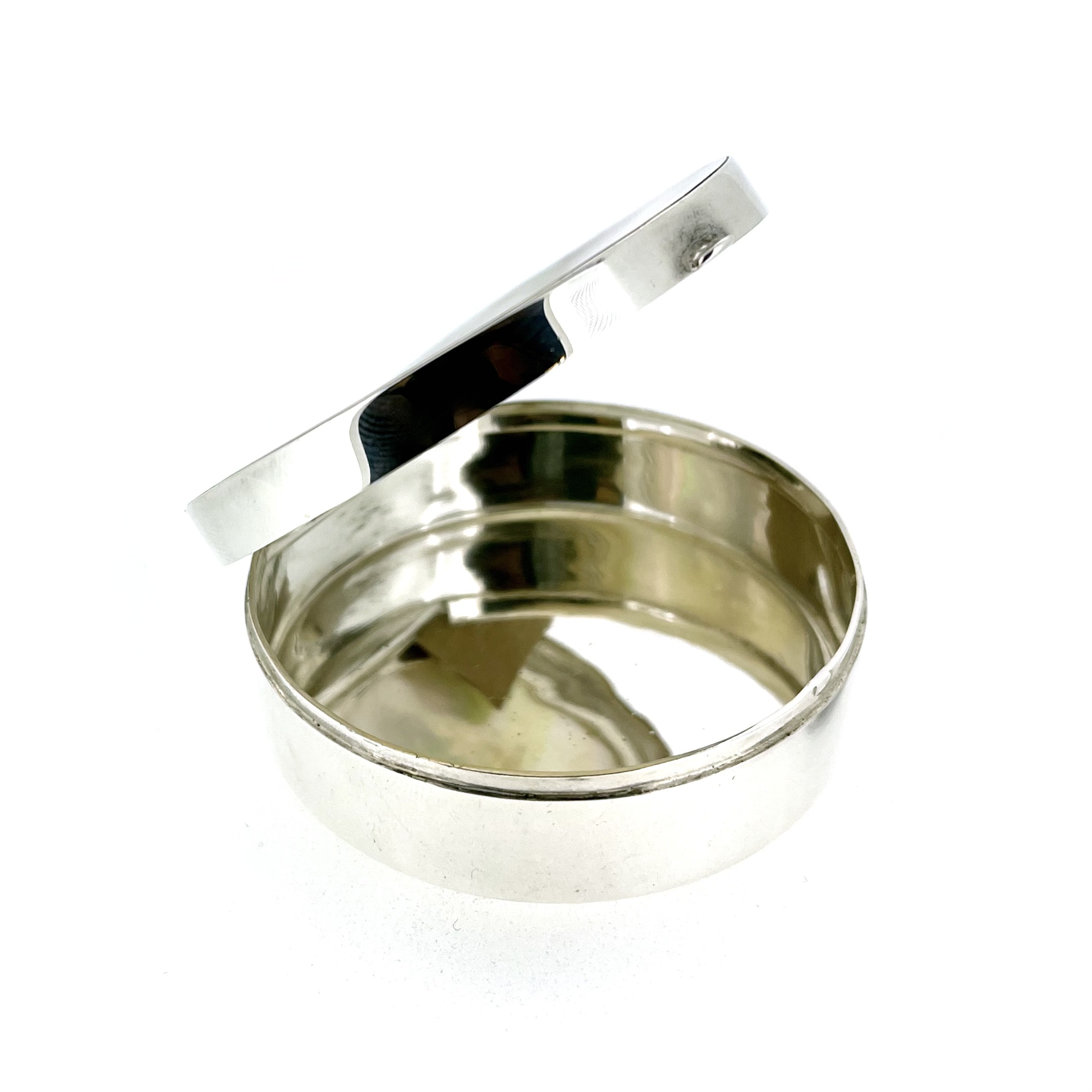 Open view of mother-of-pearl silver trinket box showing hinged lid