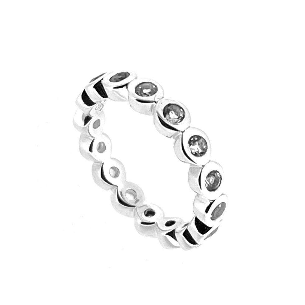 Angled view of sterling silver eternity ring with continuous white topaz