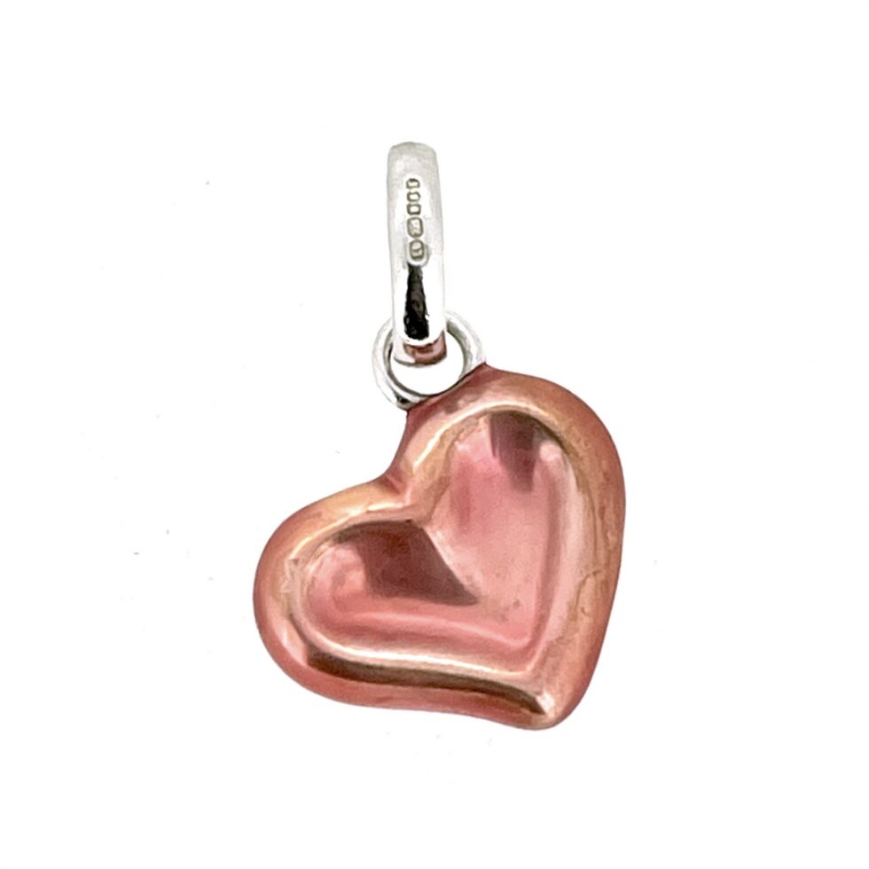 Vintage heart charm showing sculpted depression detail