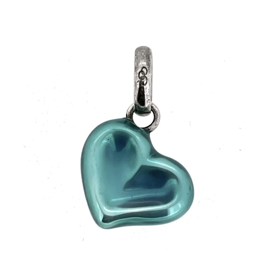 Vintage heart charm showing enamel wear detail