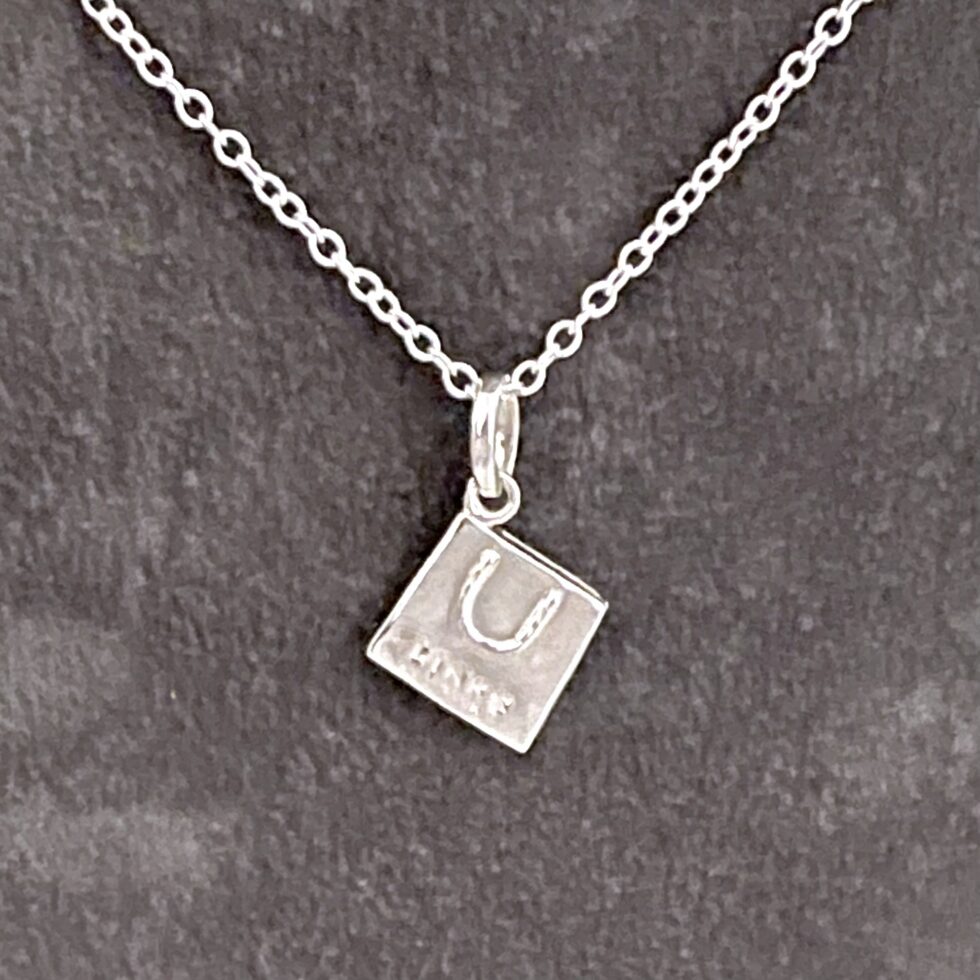 Links of London handbag charm necklace in sterling silver on oval link chain