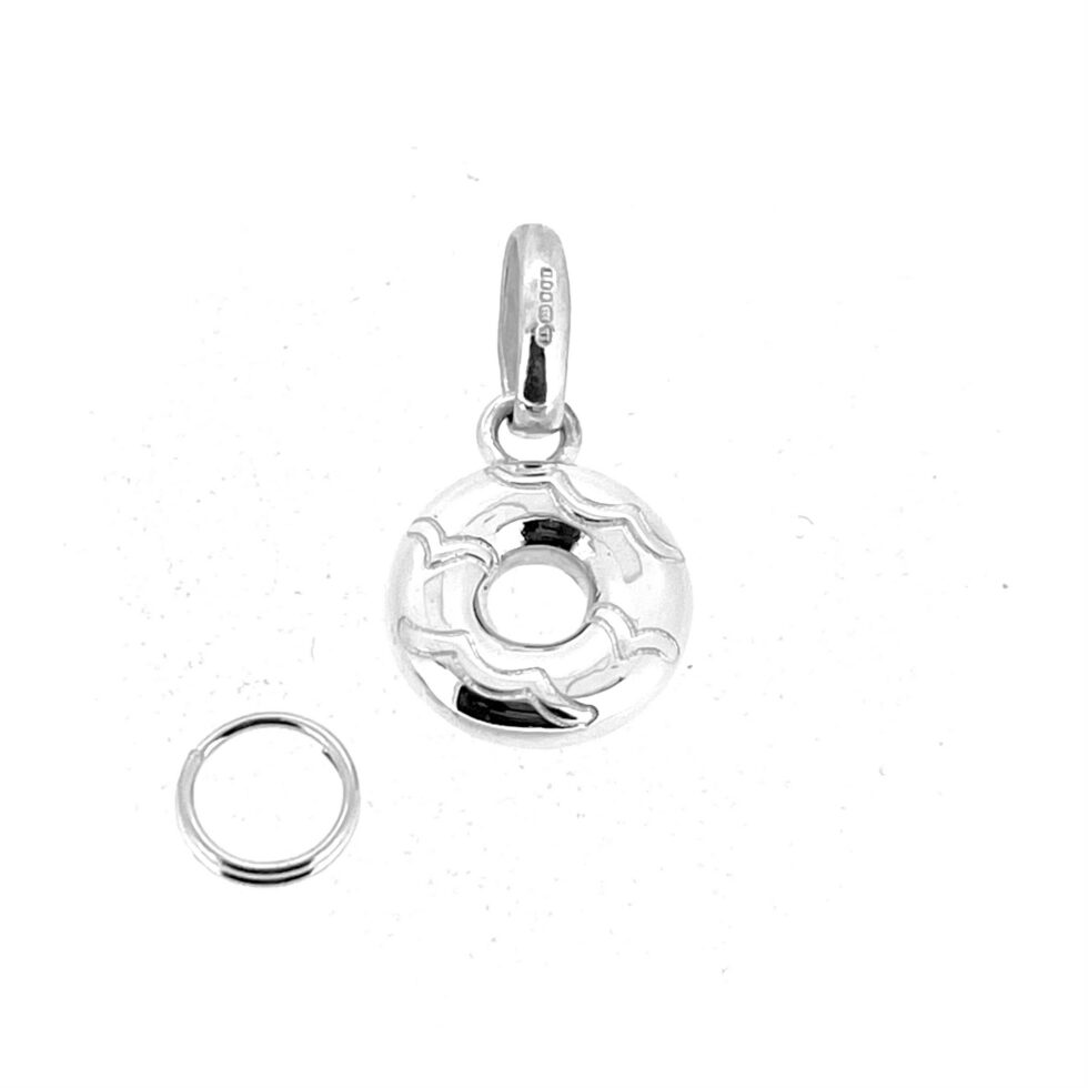 Silver doughnut charm from Links of London photographed at an angle