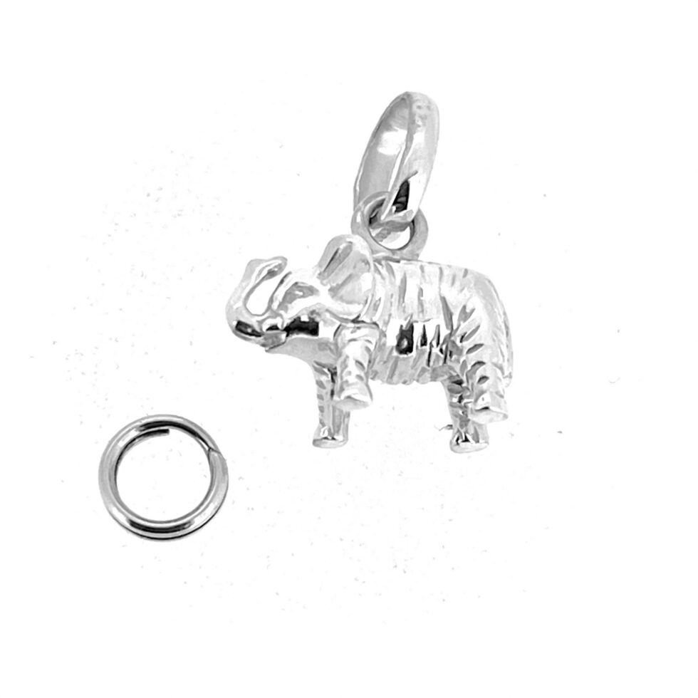 Vintage silver elephant charm showing textured line detail