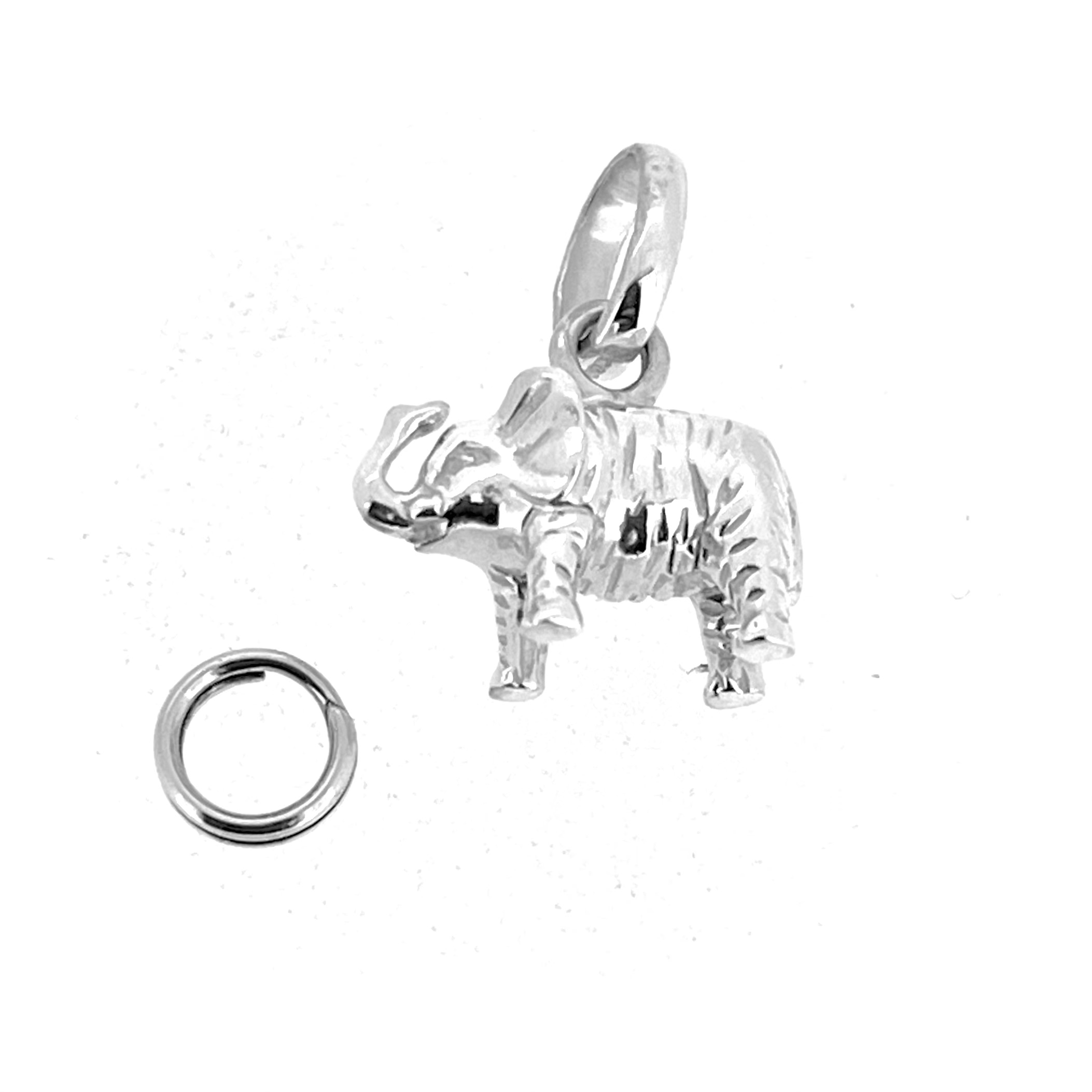 Vintage silver elephant charm showing textured line detail