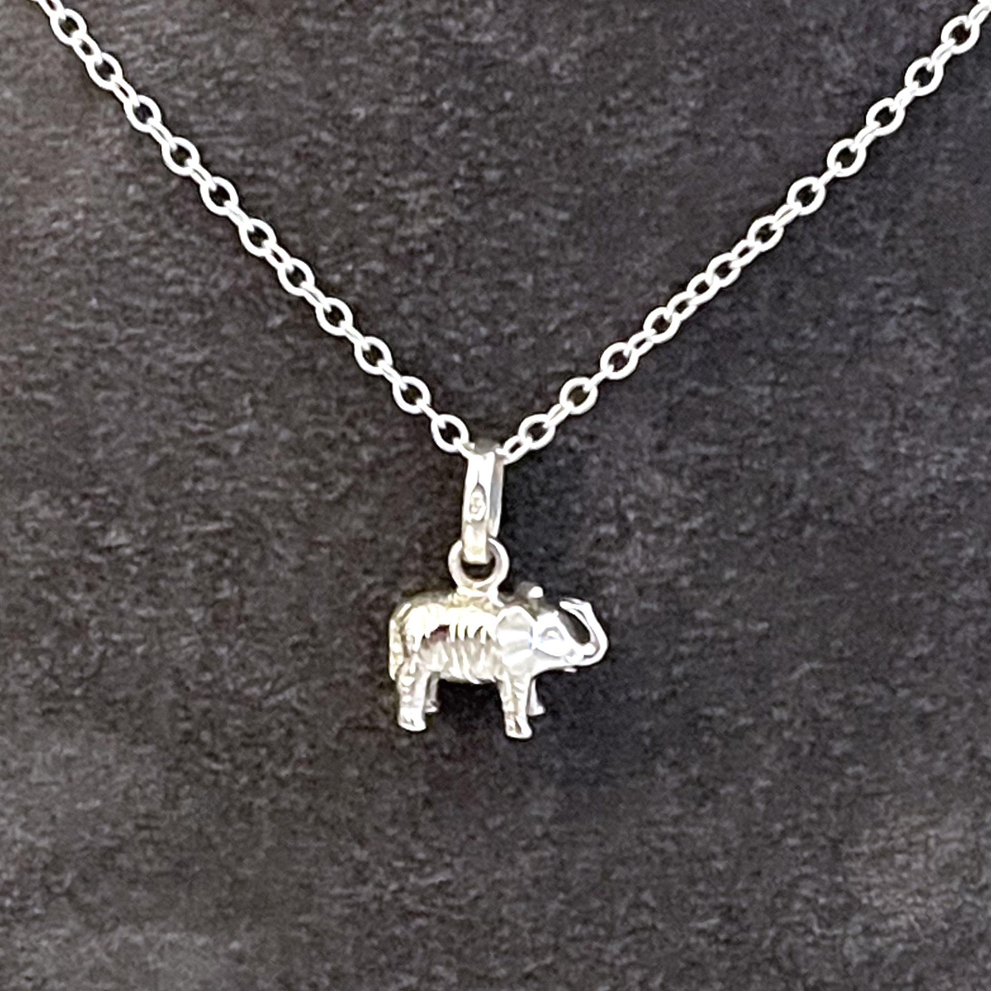 Vintage sterling silver elephant necklace with raised trunk