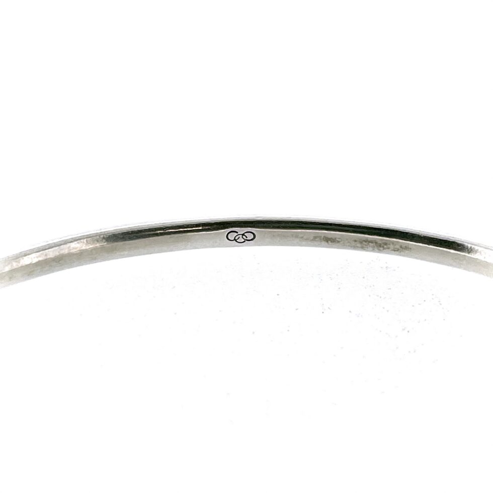 Interior view of Links of London bangle showing three-ring logo