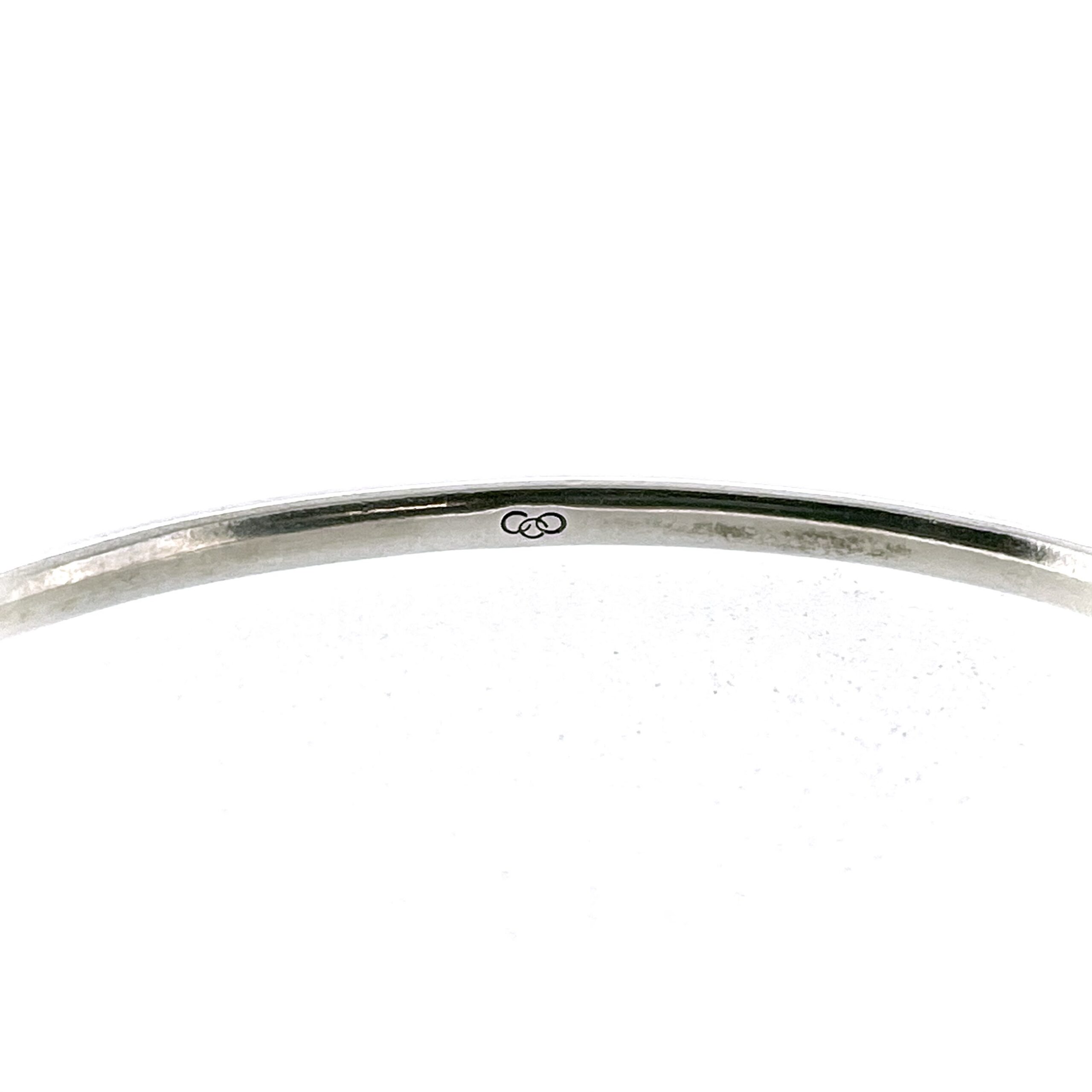 Interior view of Links of London bangle showing three-ring logo