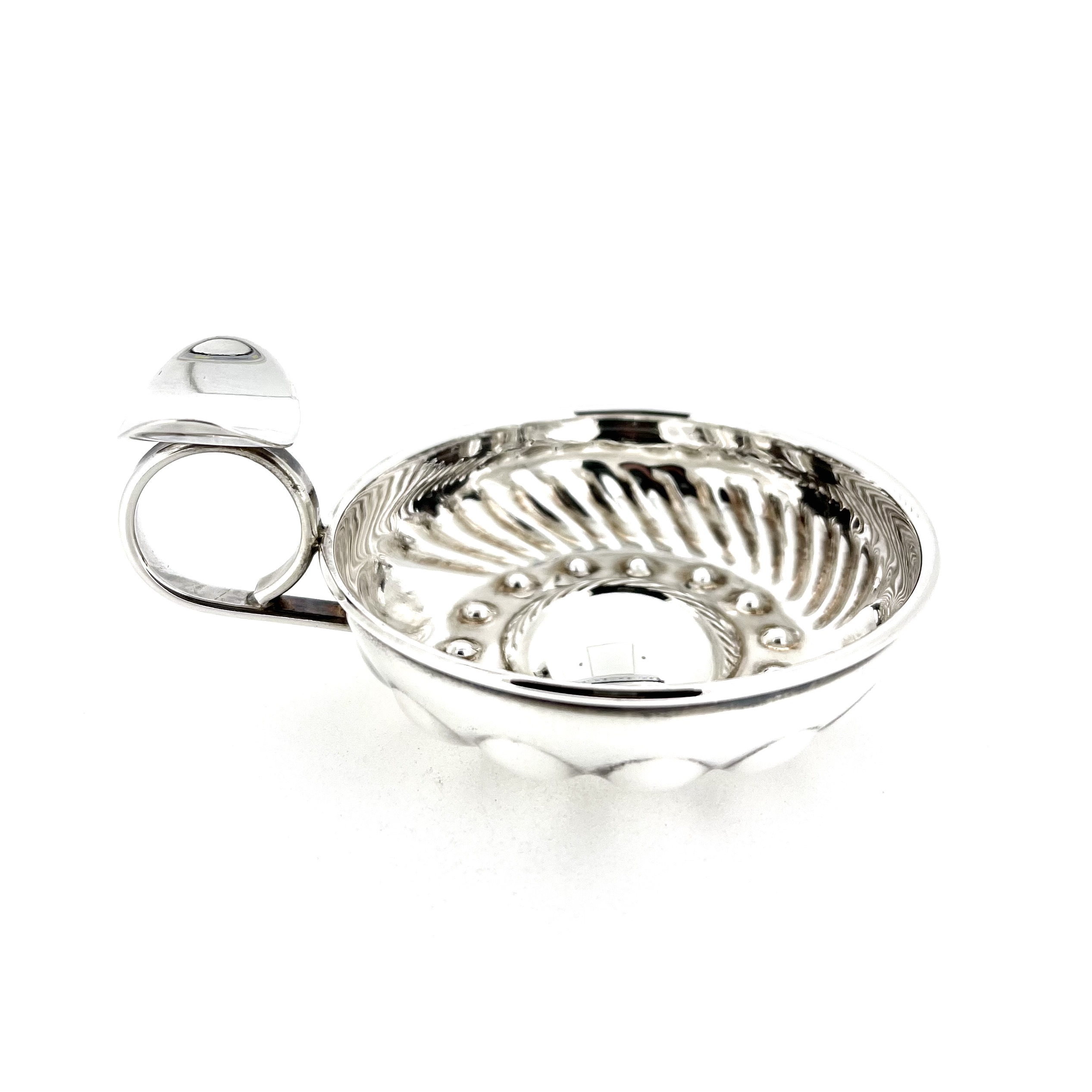 Links of London sterling silver tastevin showing textured interior and ring handle