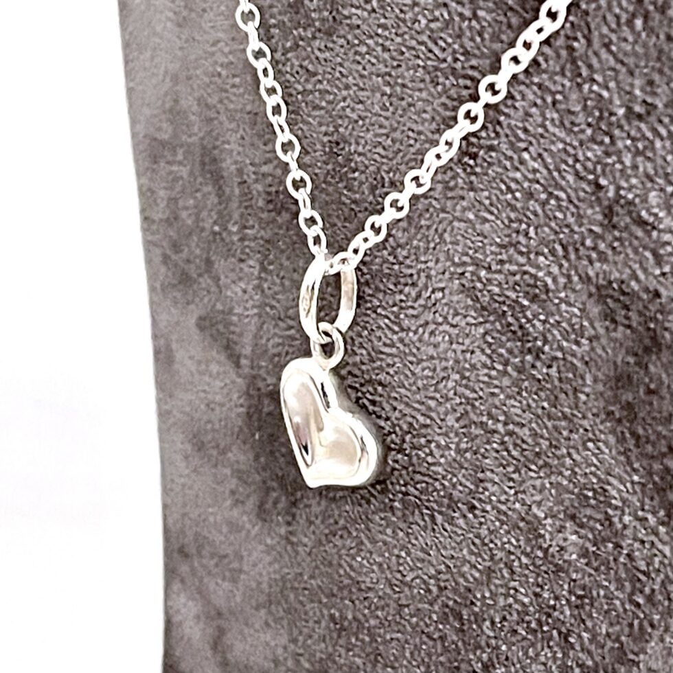 Sterling silver heart necklace with sculpted angled profile front view