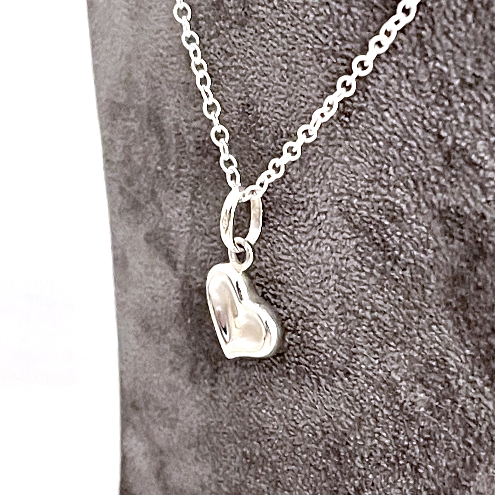 Sterling silver heart necklace with sculpted angled profile front view