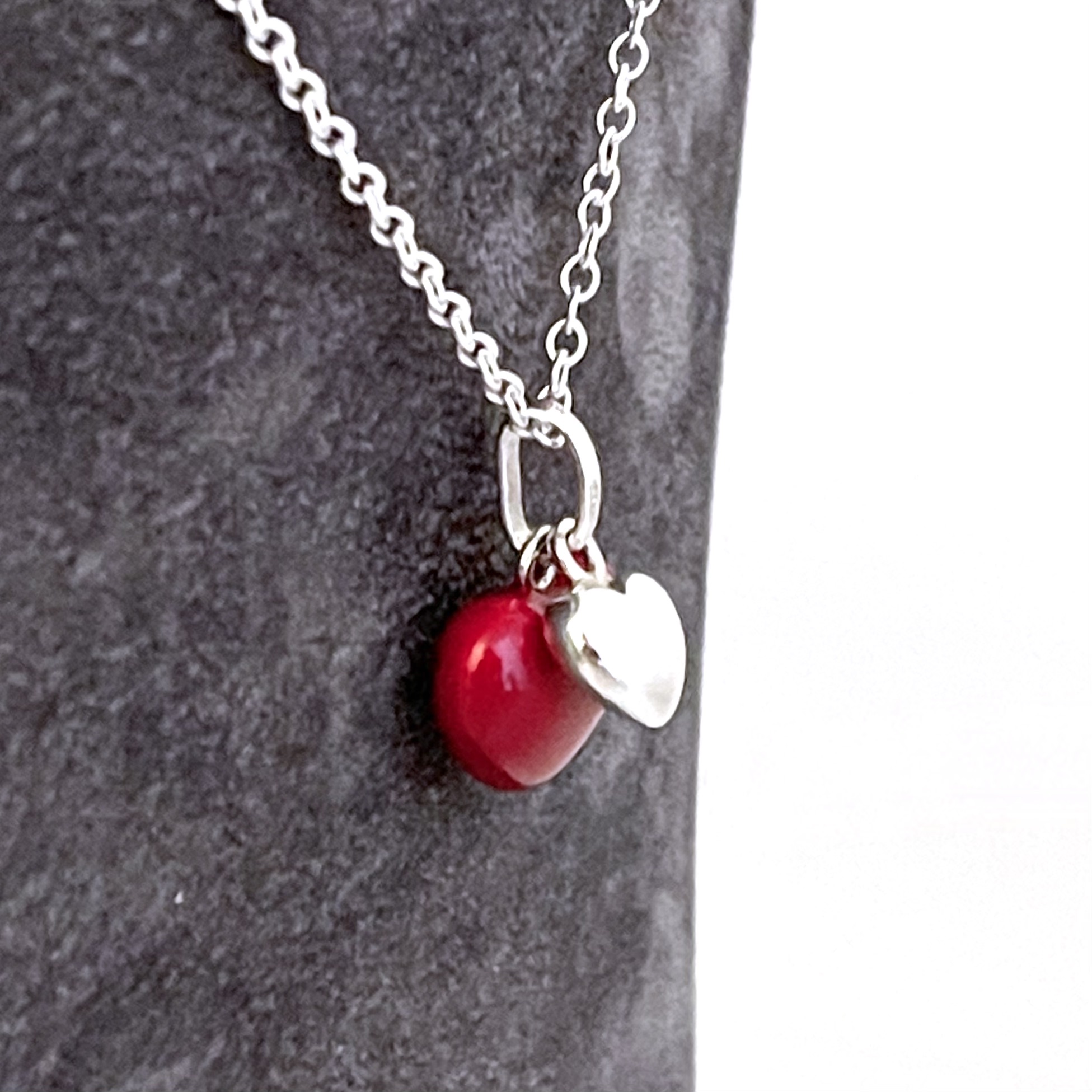 Interlinked hearts necklace with red enamel and polished silver front view