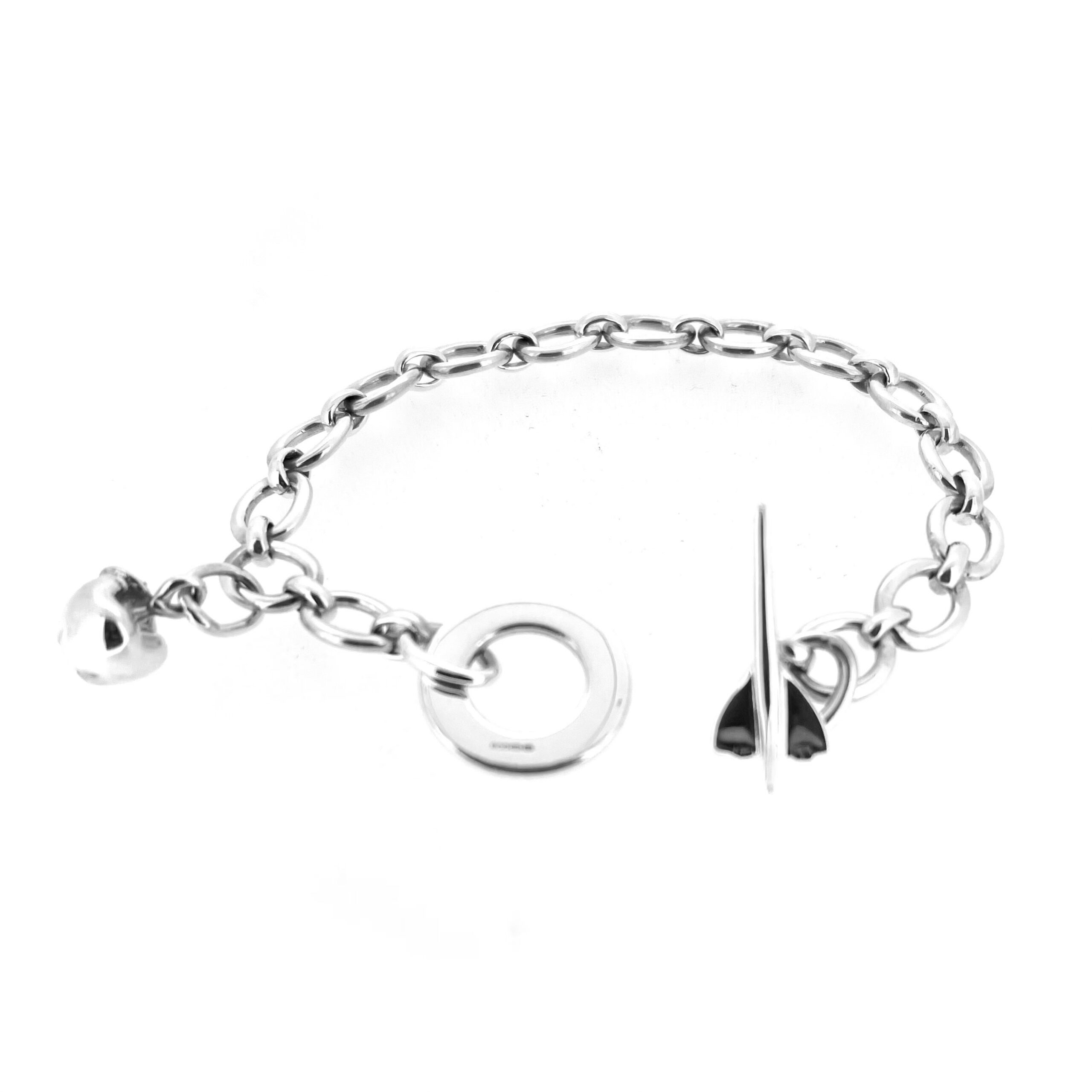 Oval link sterling silver bracelet with Concorde and apple motifs