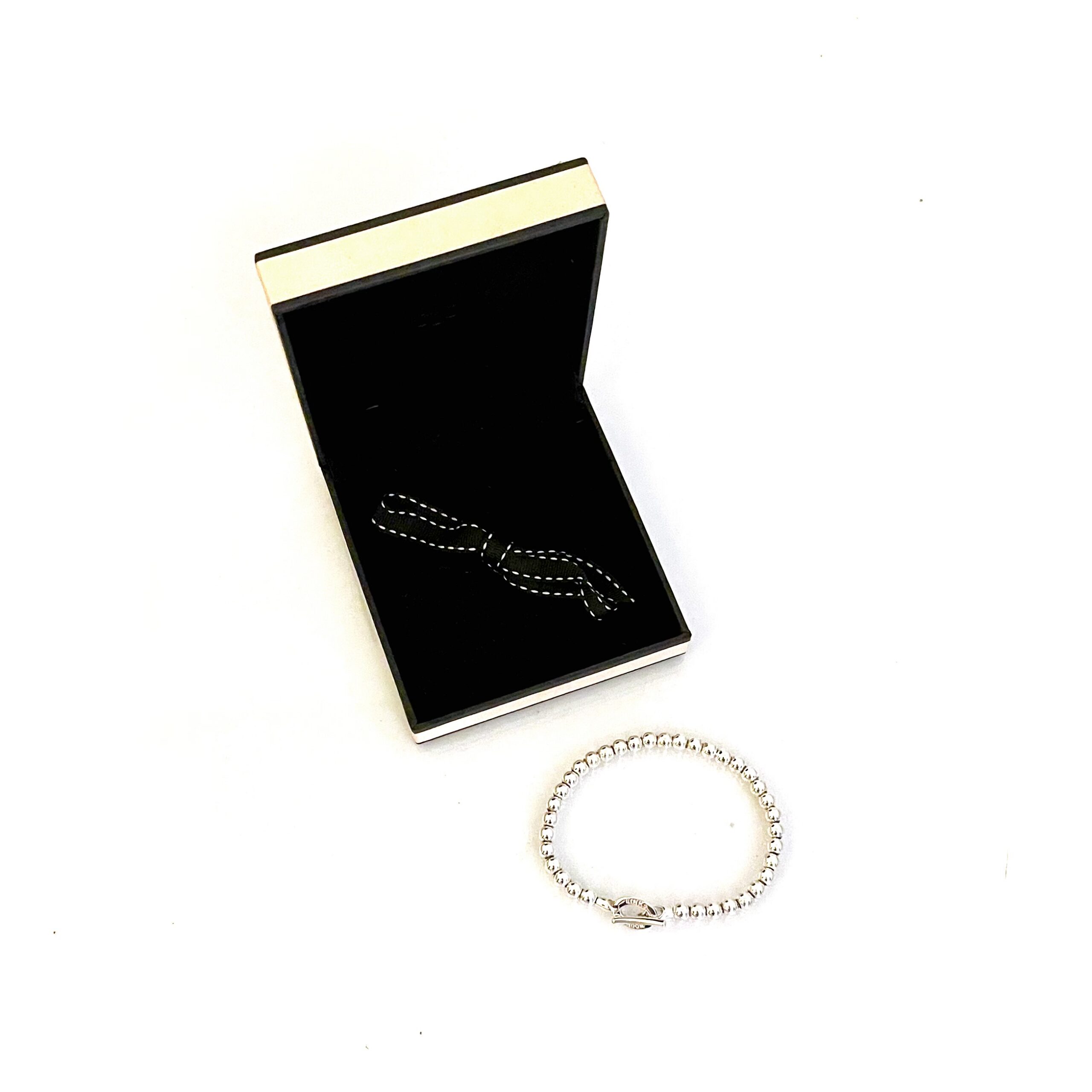 Detailed view of polished bead spacing on snake chain bracelet