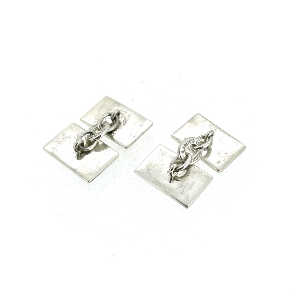 Playing card cufflinks showing all four suits
