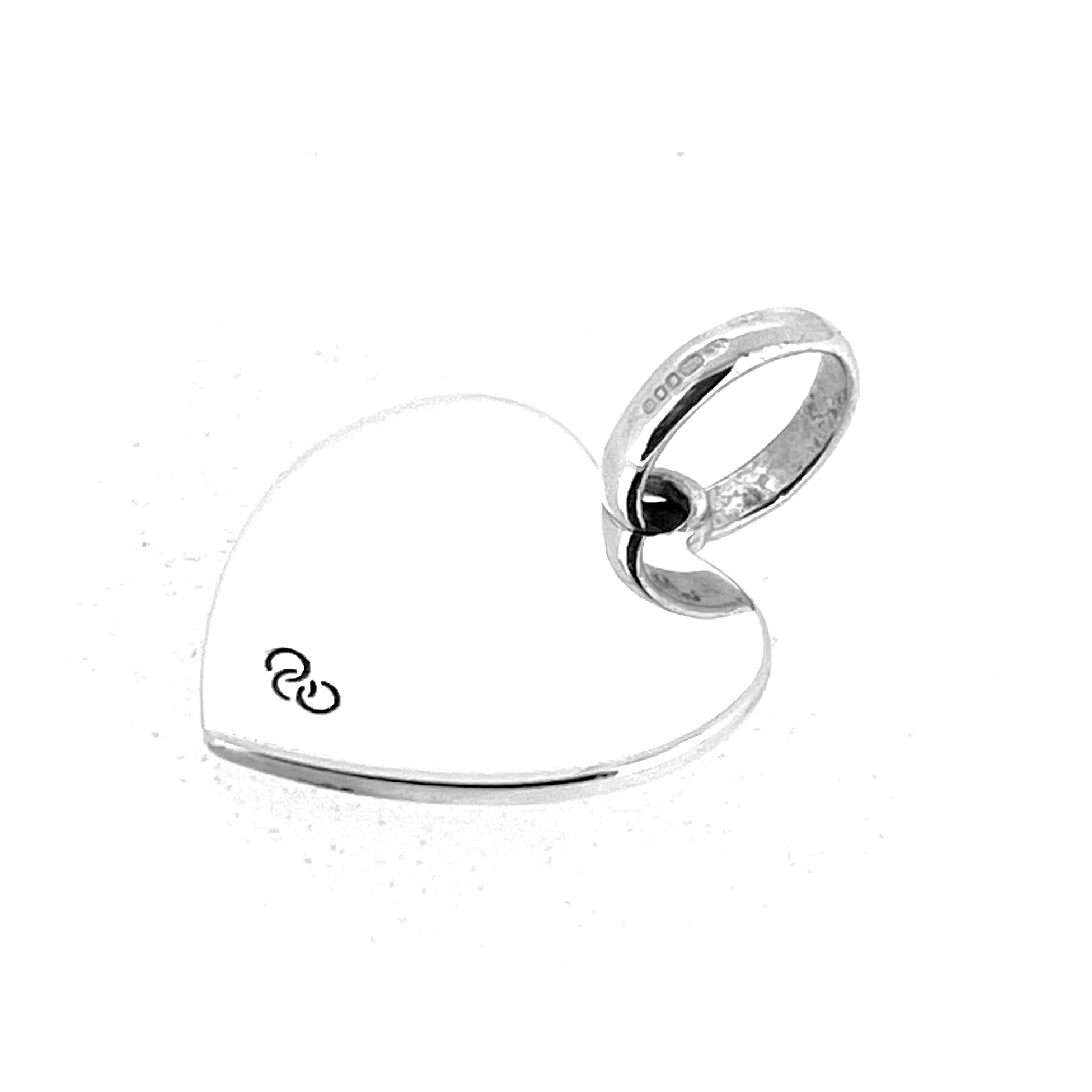 Vintage Links of London heart charm showing polished silver surface
