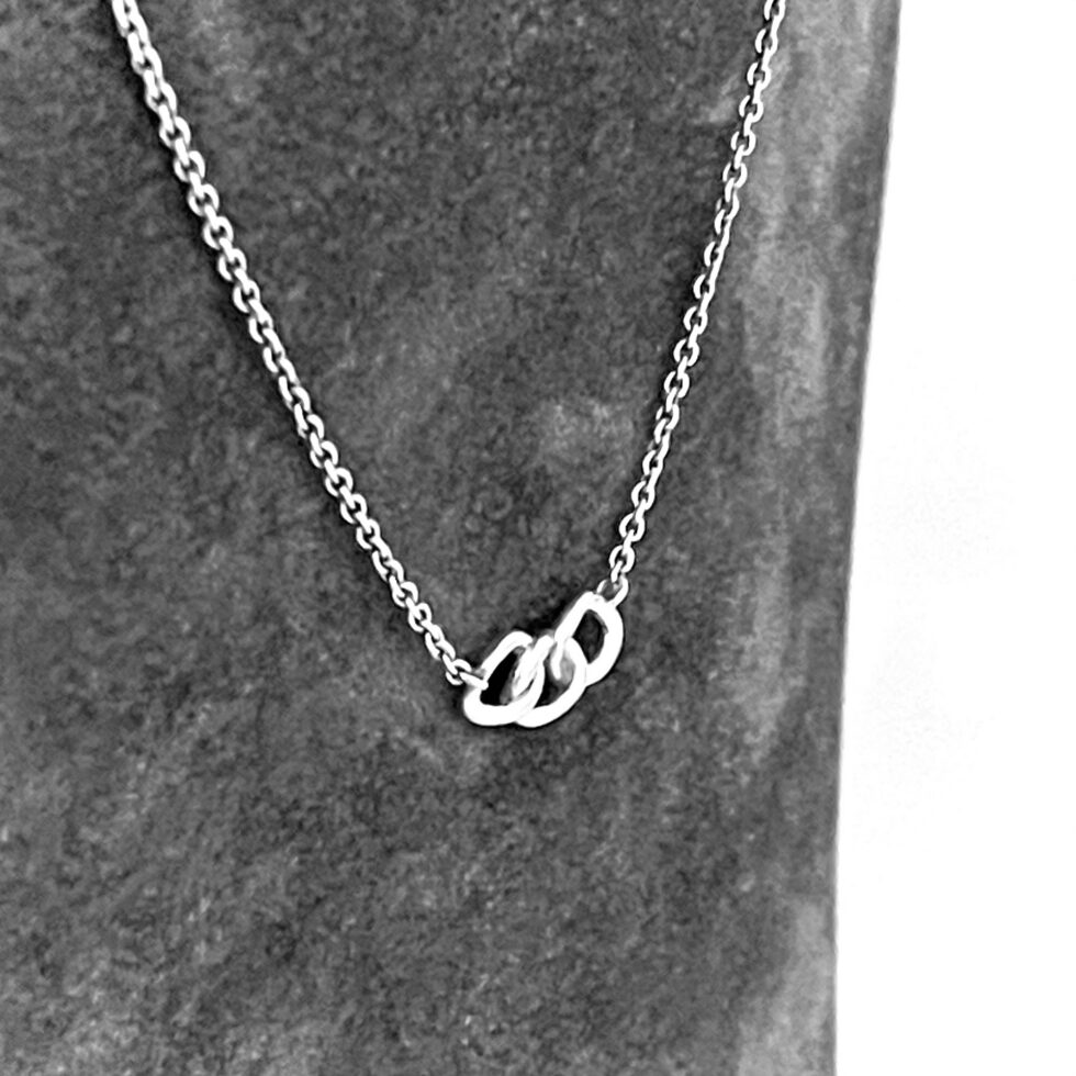 Sterling silver three-ring necklace with polished finish