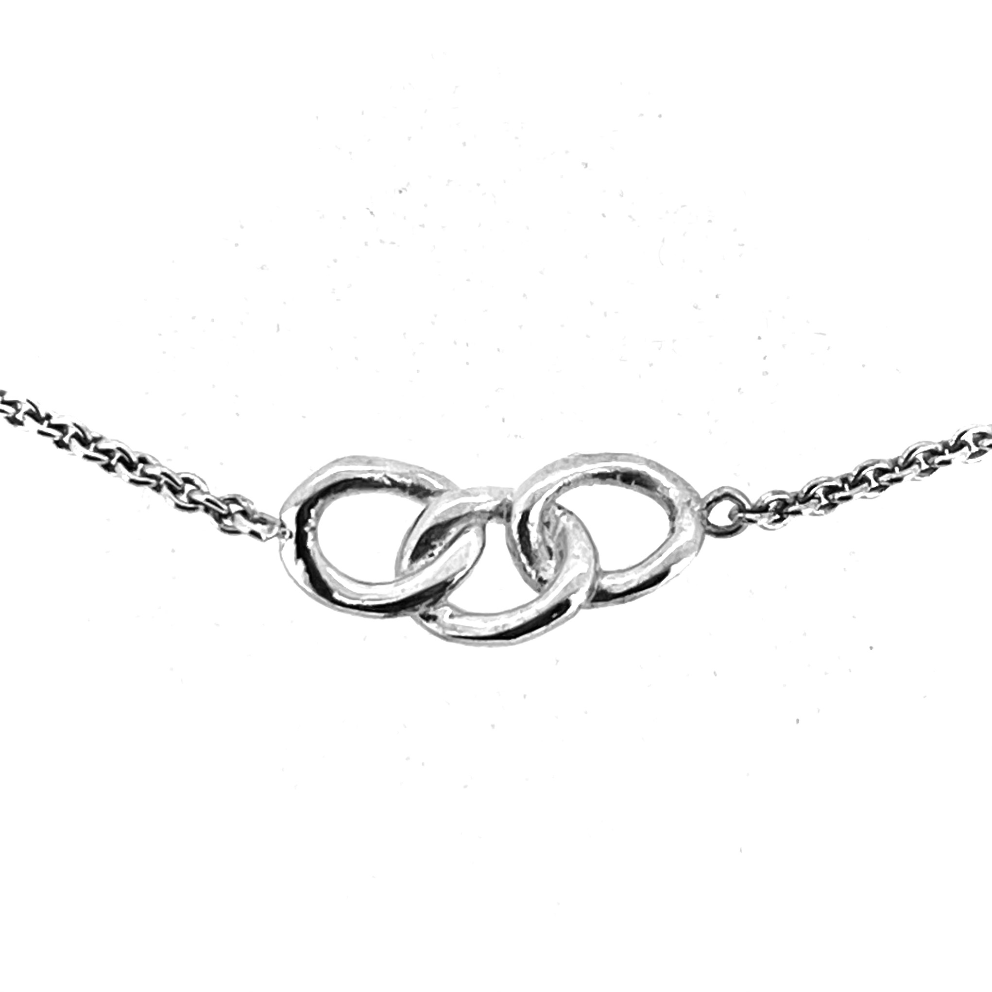 Signature bracelet with three interlocking ring motifs