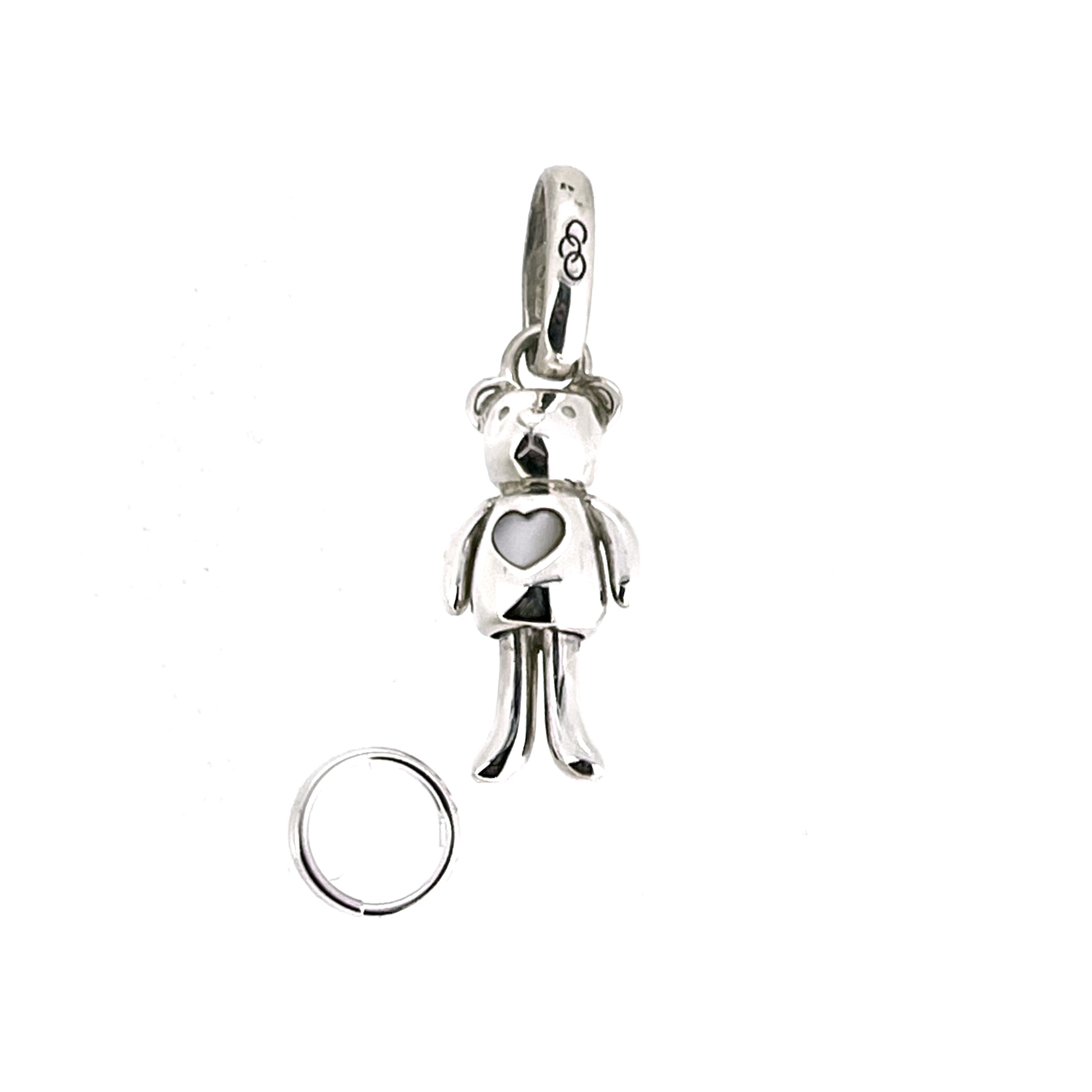 A tiny sterling silver teddy with a mother-of-pearl heart.